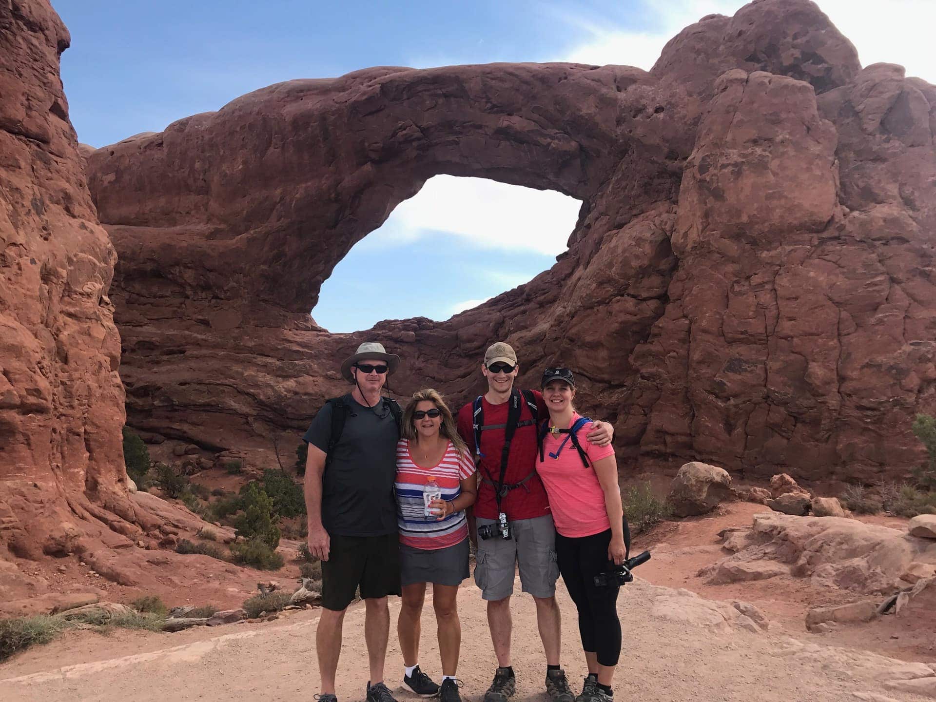 Lindsey's friends in front of a massive arch at Arches National Park