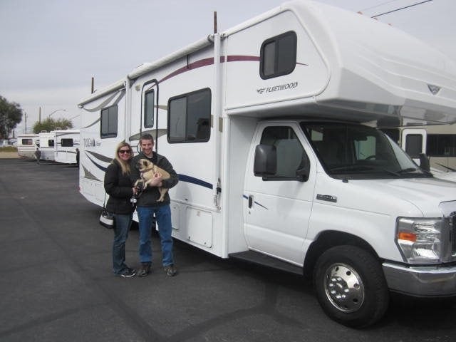 Keith, Lindsey, and Lexi standing in front of our new motorhome