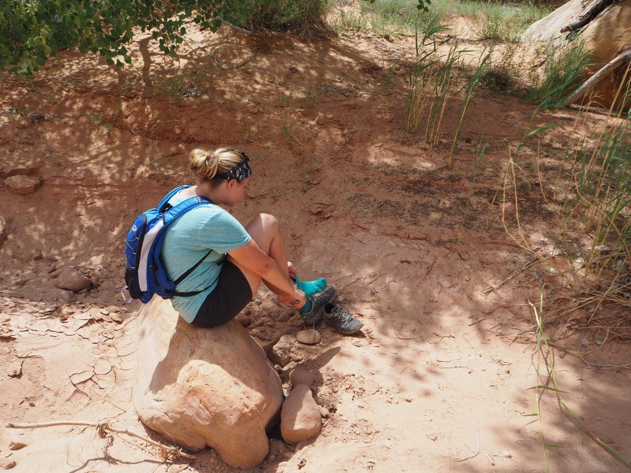 Lindsey is dumping sand from her shoes (again...)