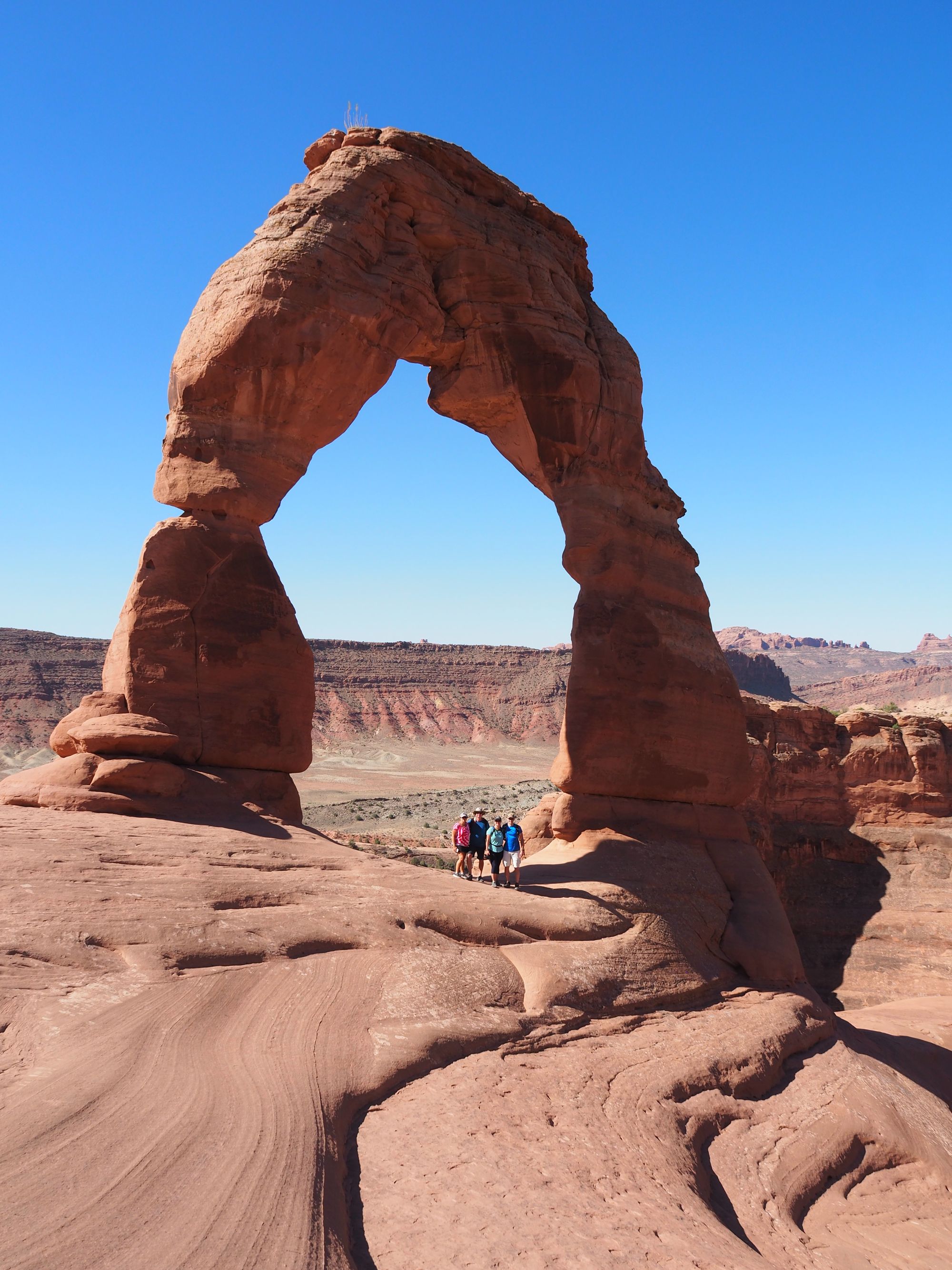 Standing under the massive Delicate Arch in Arches National Park
