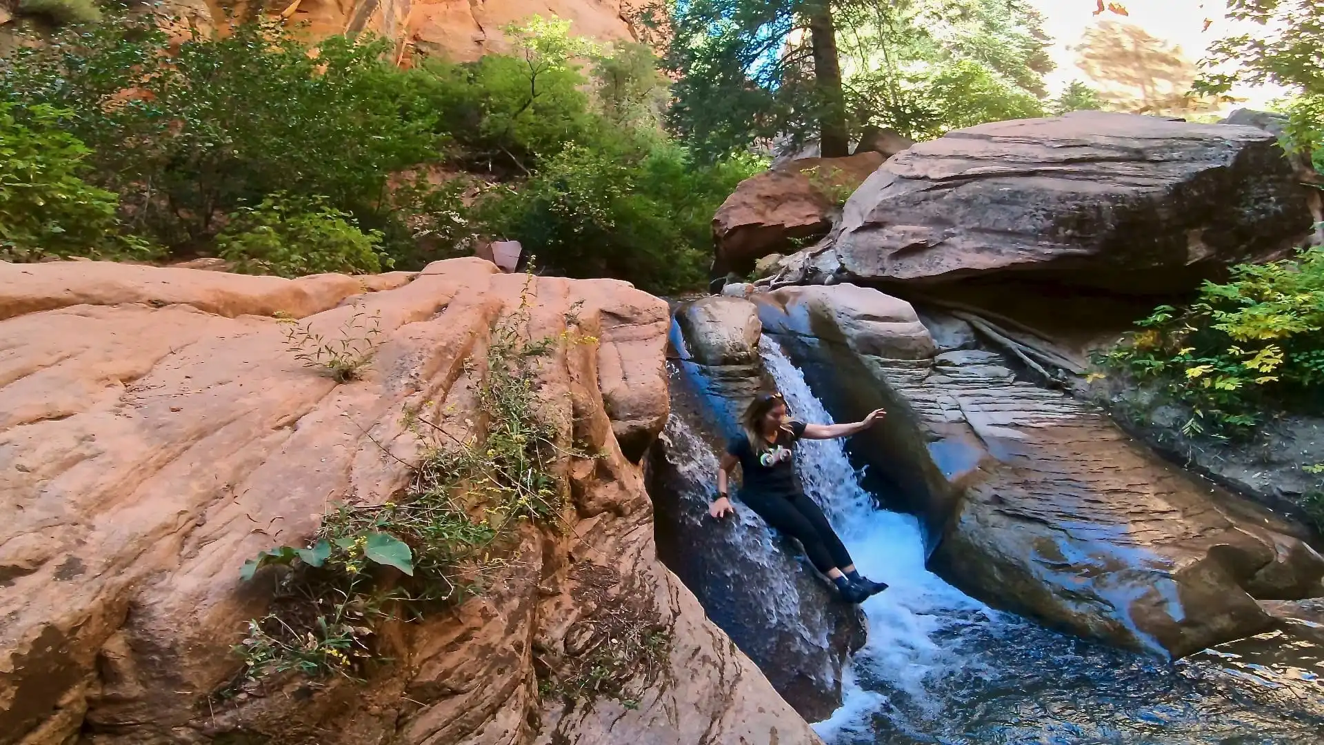 Lindsey is enjoying playing on the natural water slides in the canyon