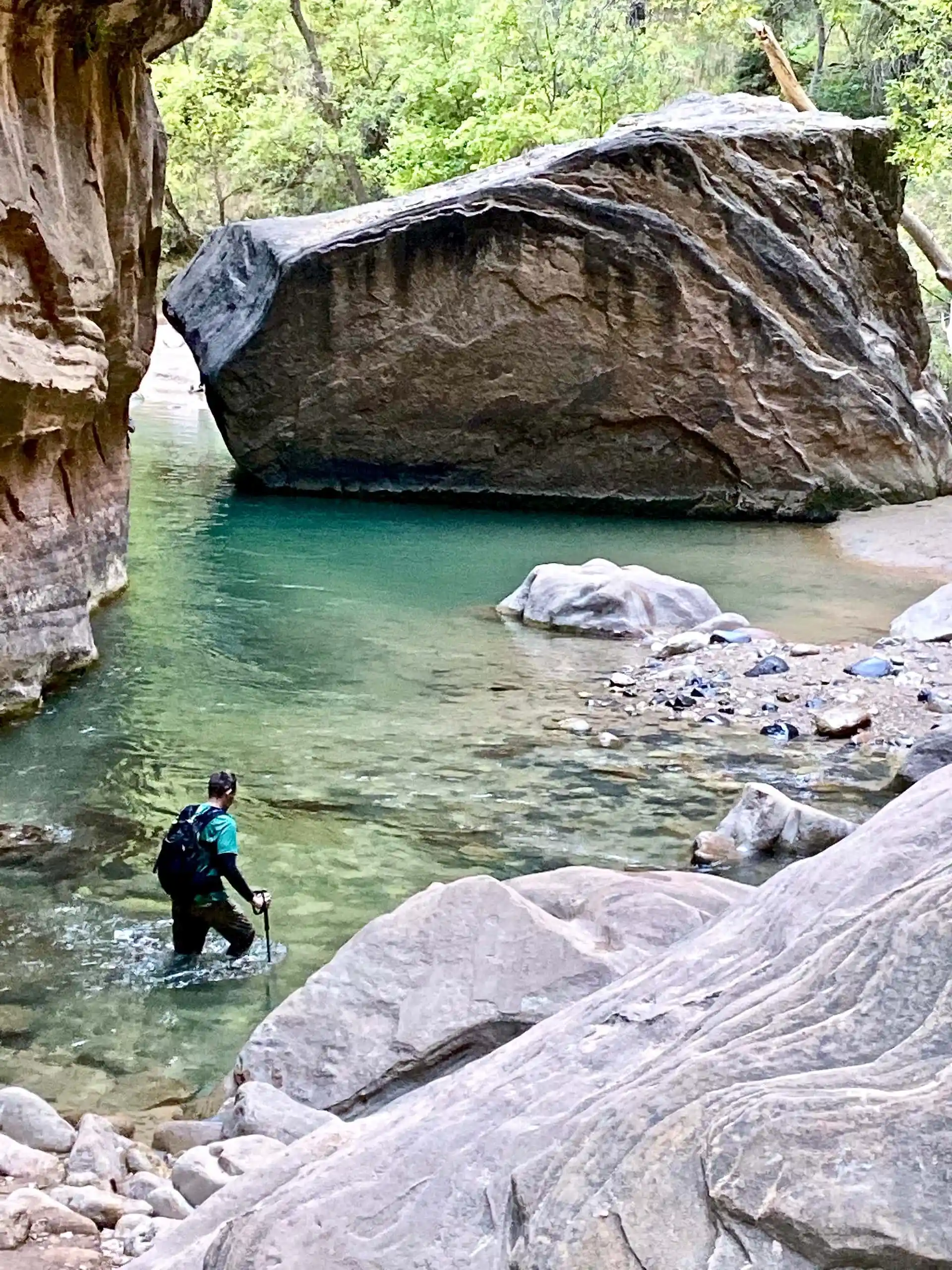 Keith is hiking near a massive boulder in the Virgin River