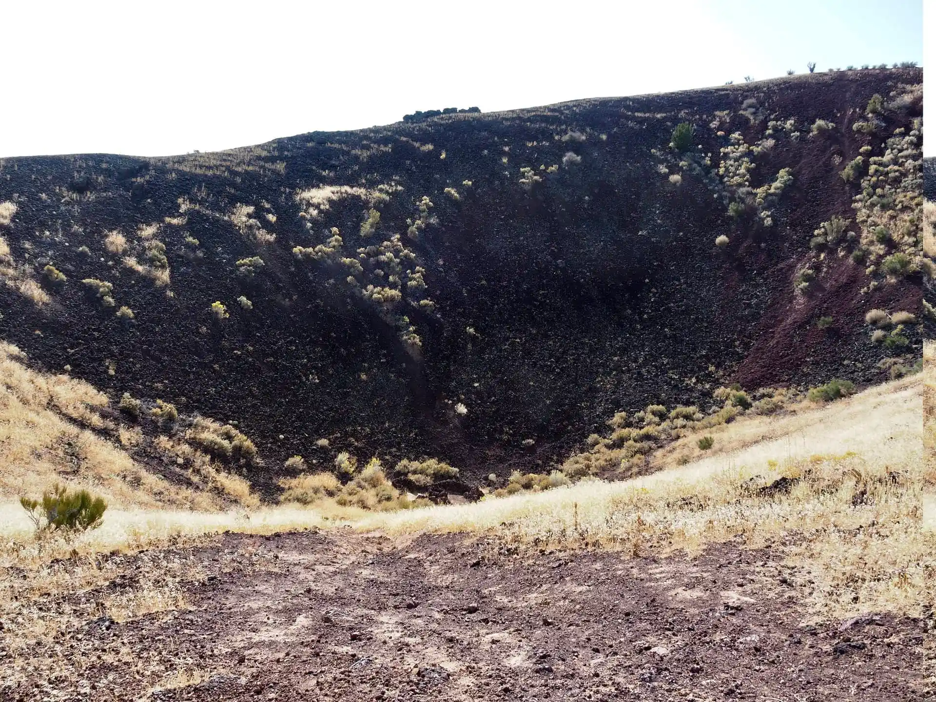 The cinder cone is filled with black lava rock