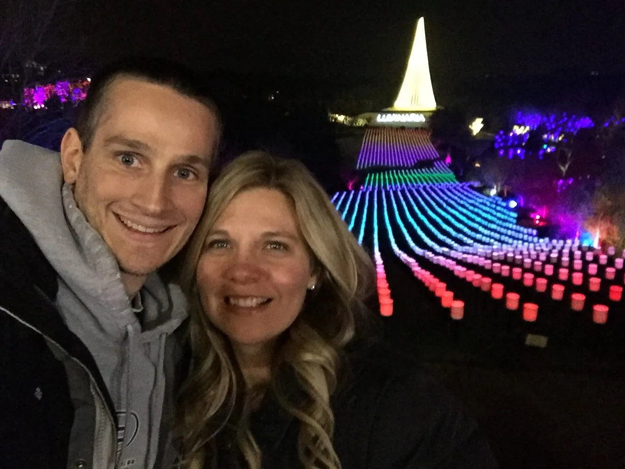 Taking a selfie in front of a large light display at Luminaria