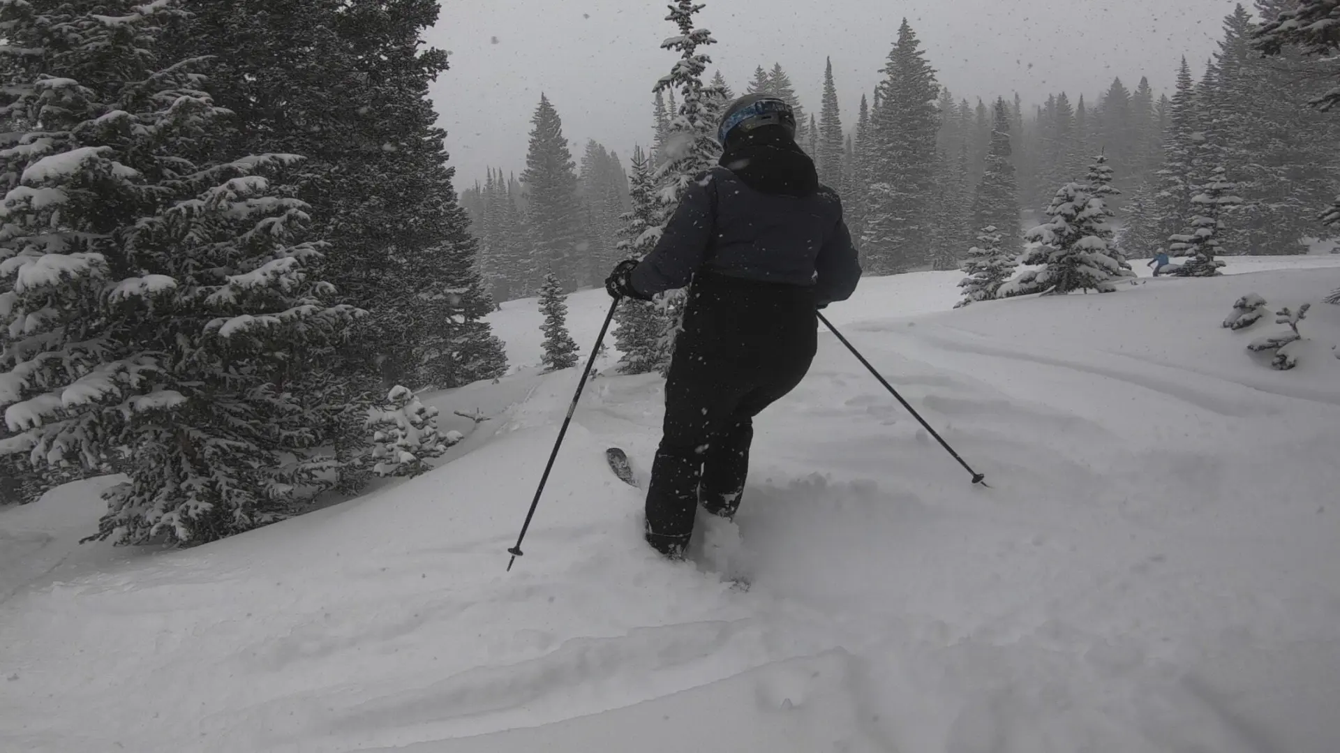 Lindsey skiing through powder while wearing all of her ski gear