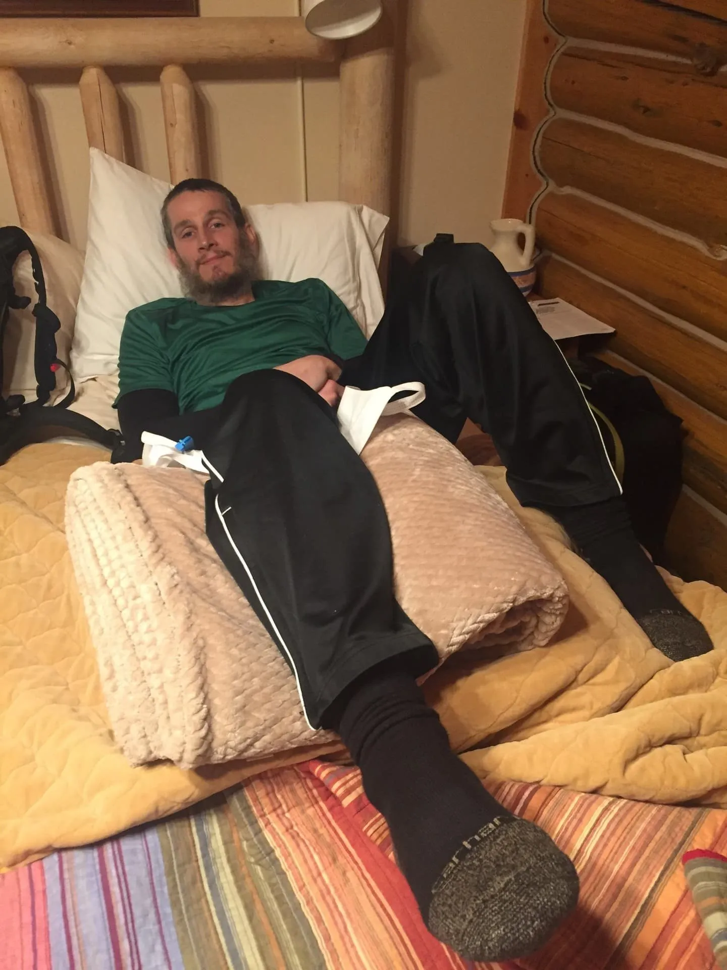Keith trying to relax in bed after tearing his ACL while skiing