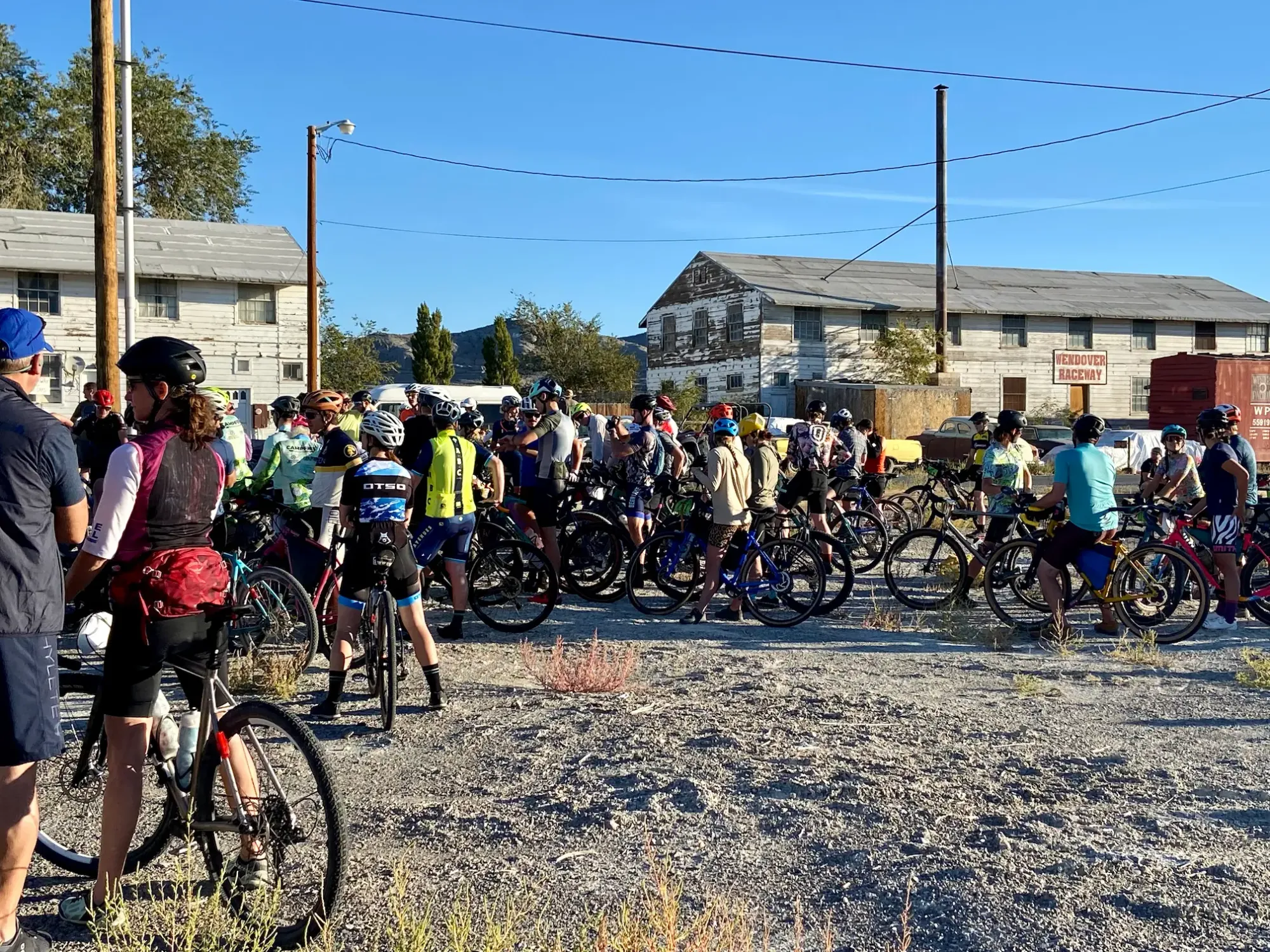 A crowd of racers is lined up at the start of the Salty Lizard 100 gravel race.
