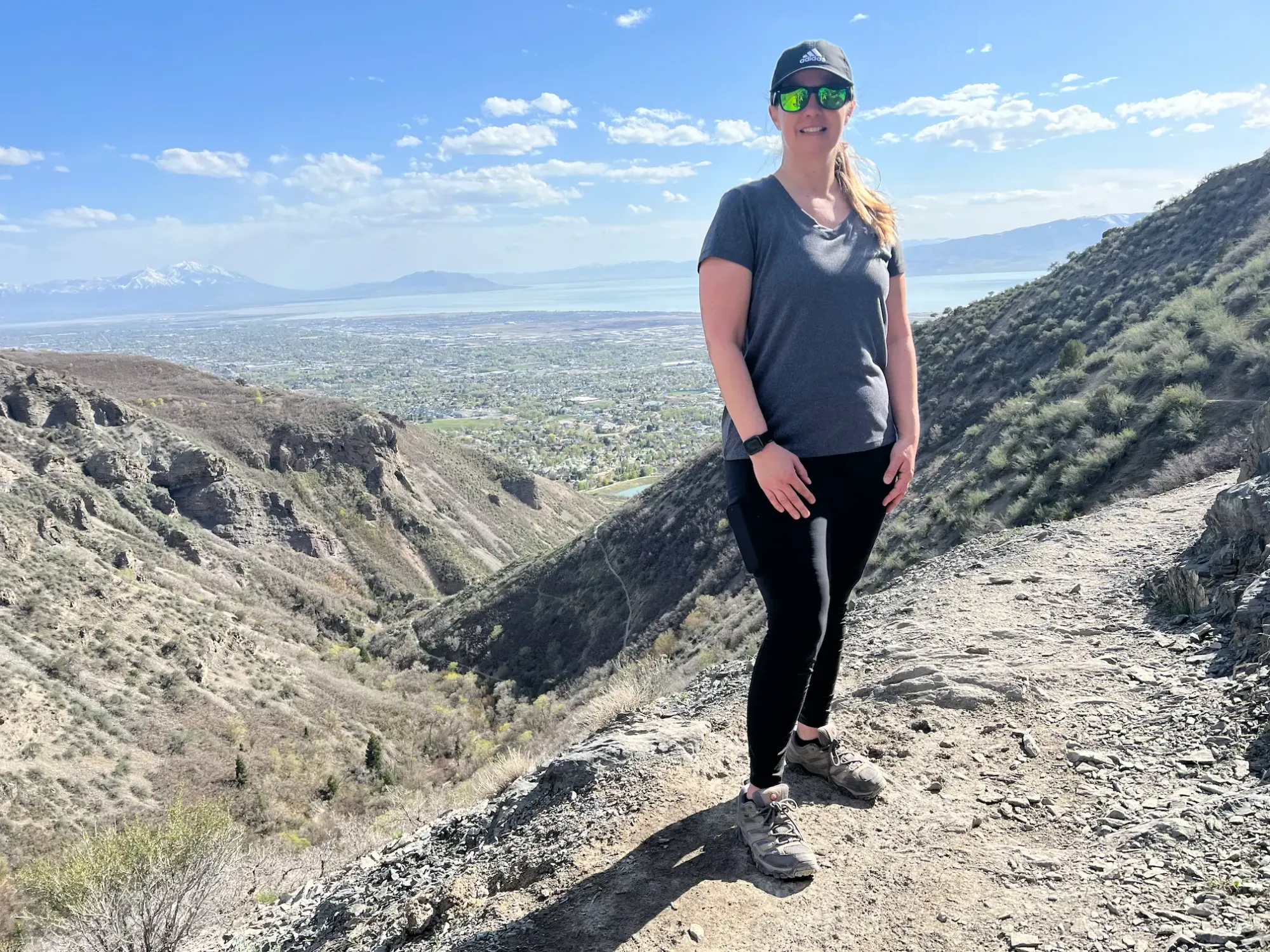 Lindsey is posing for a photo at a beautiful overlook area on the Grove Creek Canyon trail