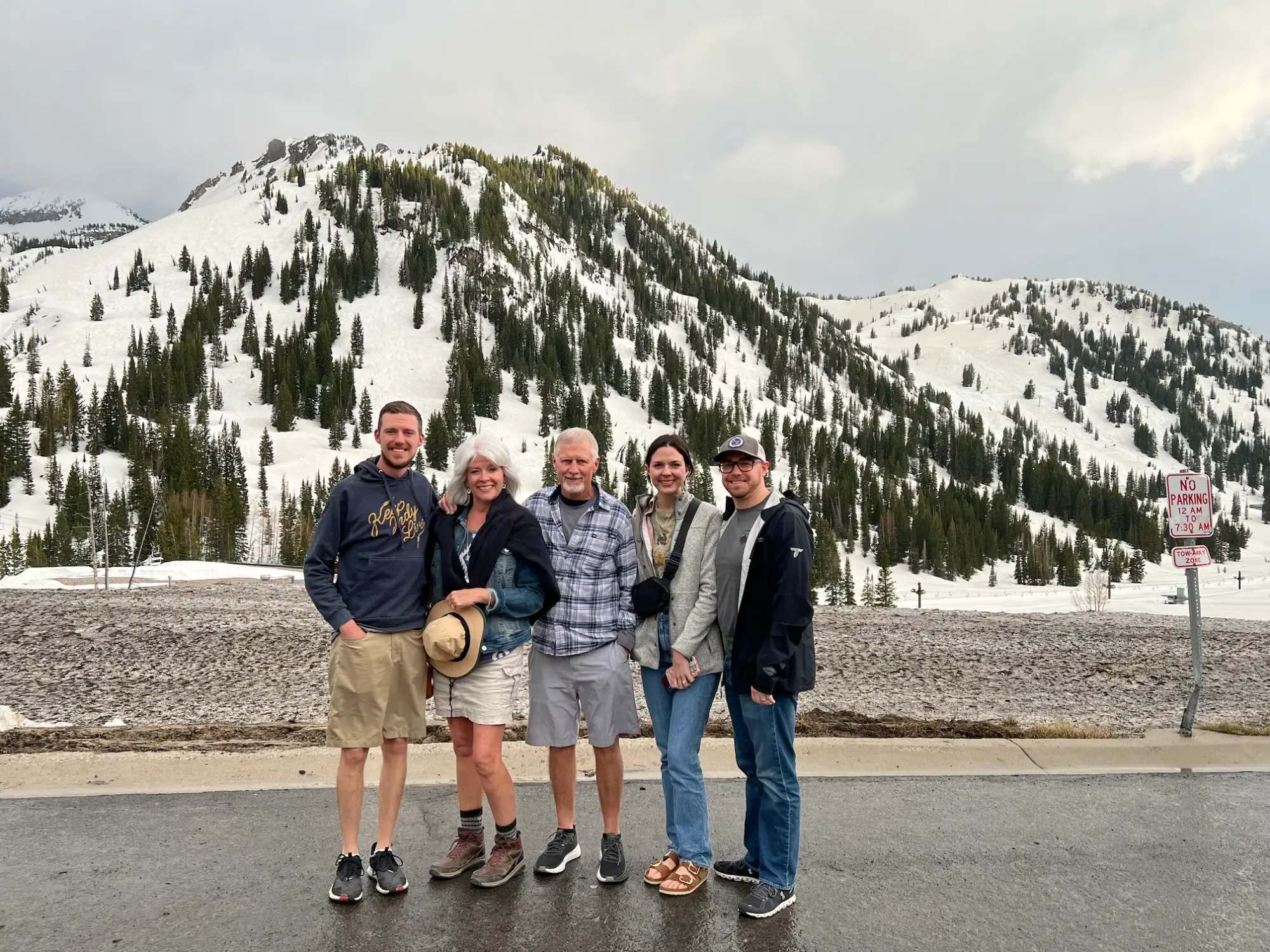 Dan and his family are posing in front of the Alta Ski Area in Little Cottonwood Canyon 