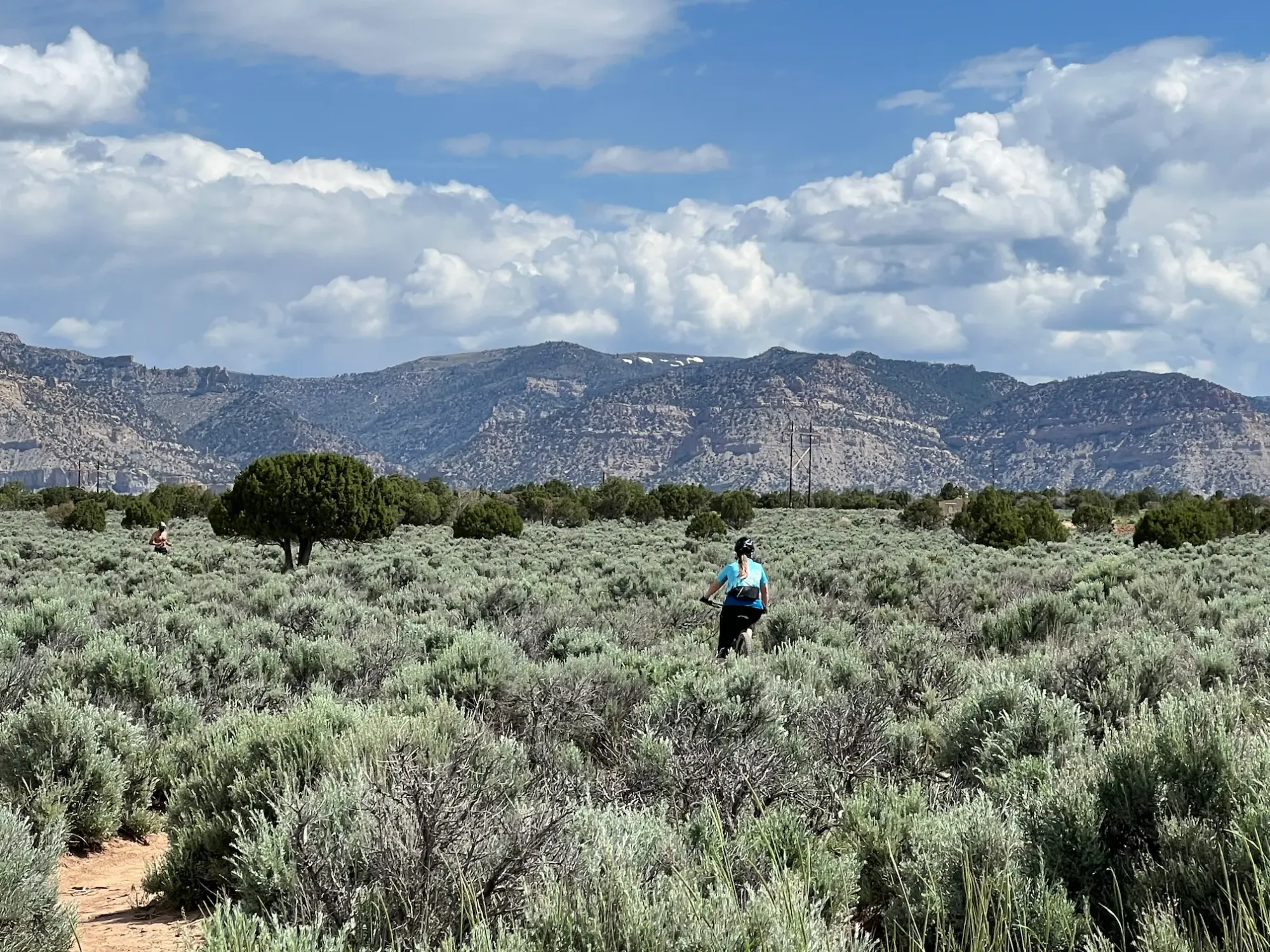 Lindsey is riding her mountain bike on the Solis Connector Trail at the Wood Hill Trail System in Price, UT