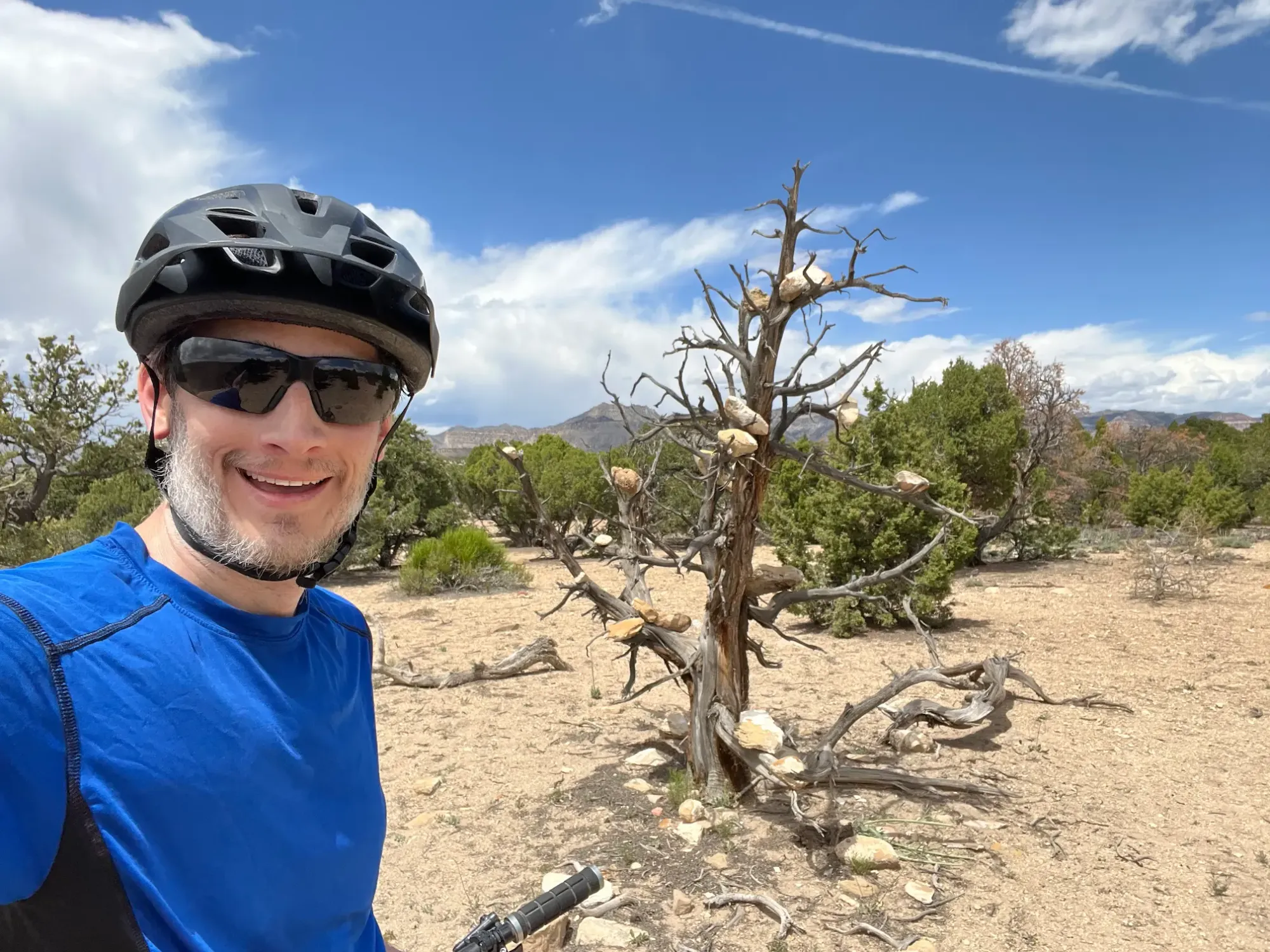 Keith is taking a selfie in front of one of the many adorned trees at the Wood Hill Trail System