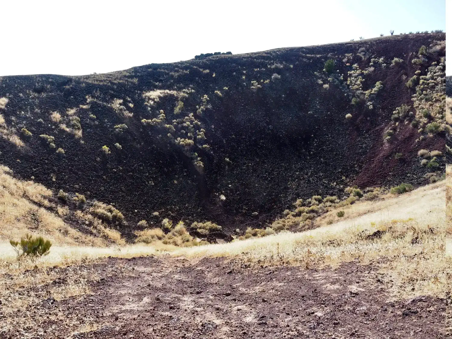 The cinder cone is filled with black lava rock