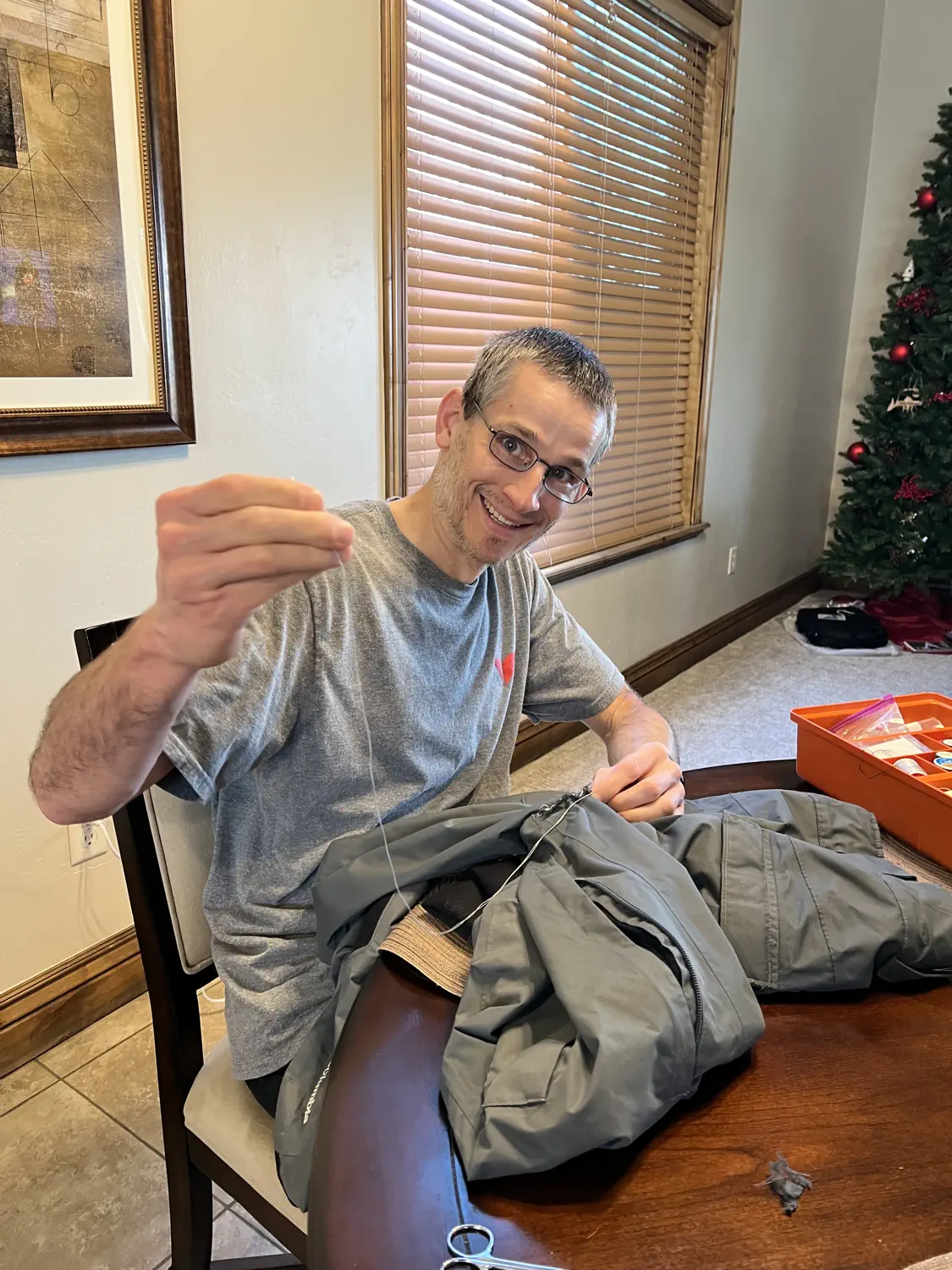 Keith is sewing his ski pants, yet again, before heading out to ski at Snowbird
