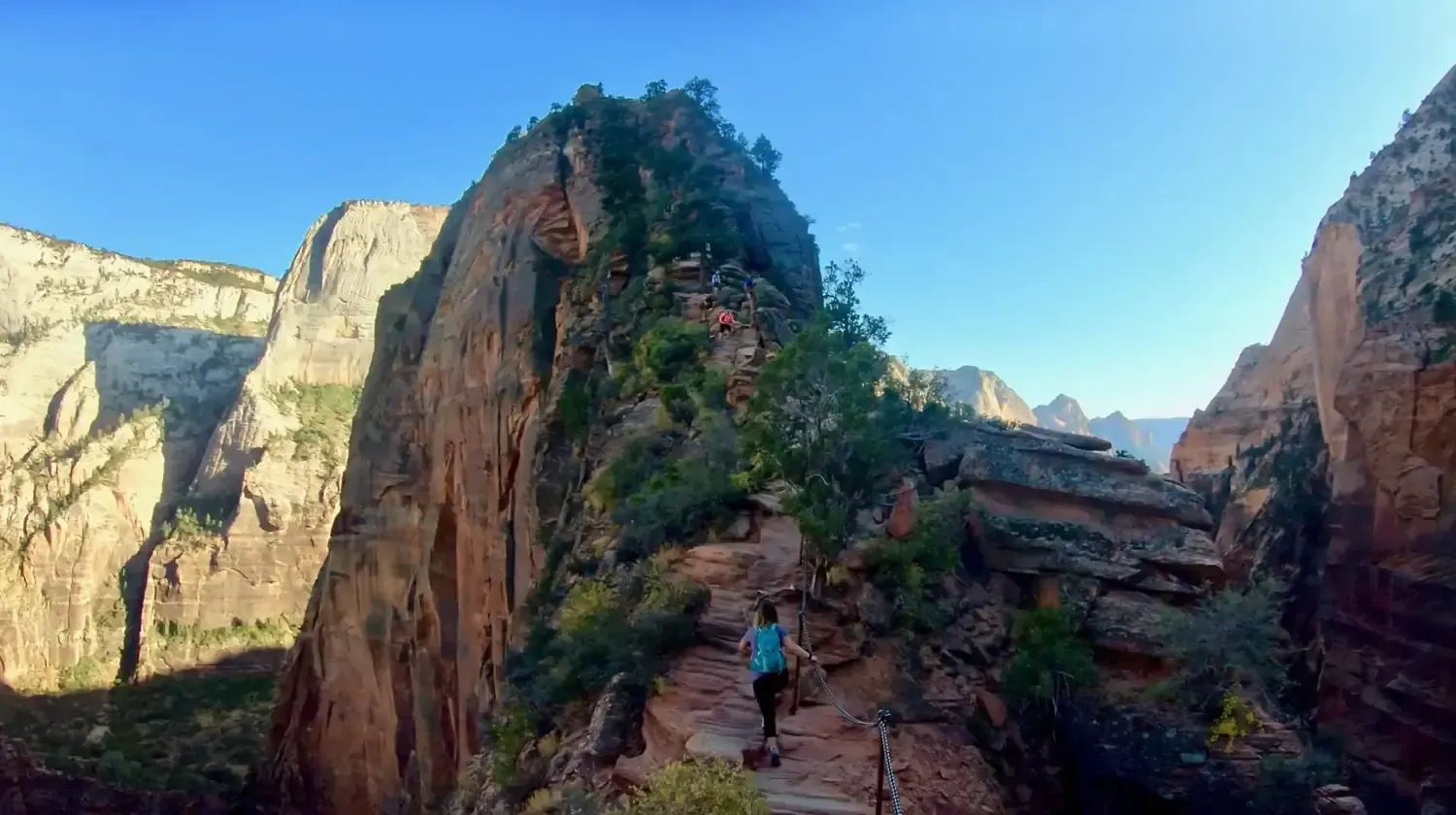 Lindsey is traversing the precarious chain section of the Angels Landing hike