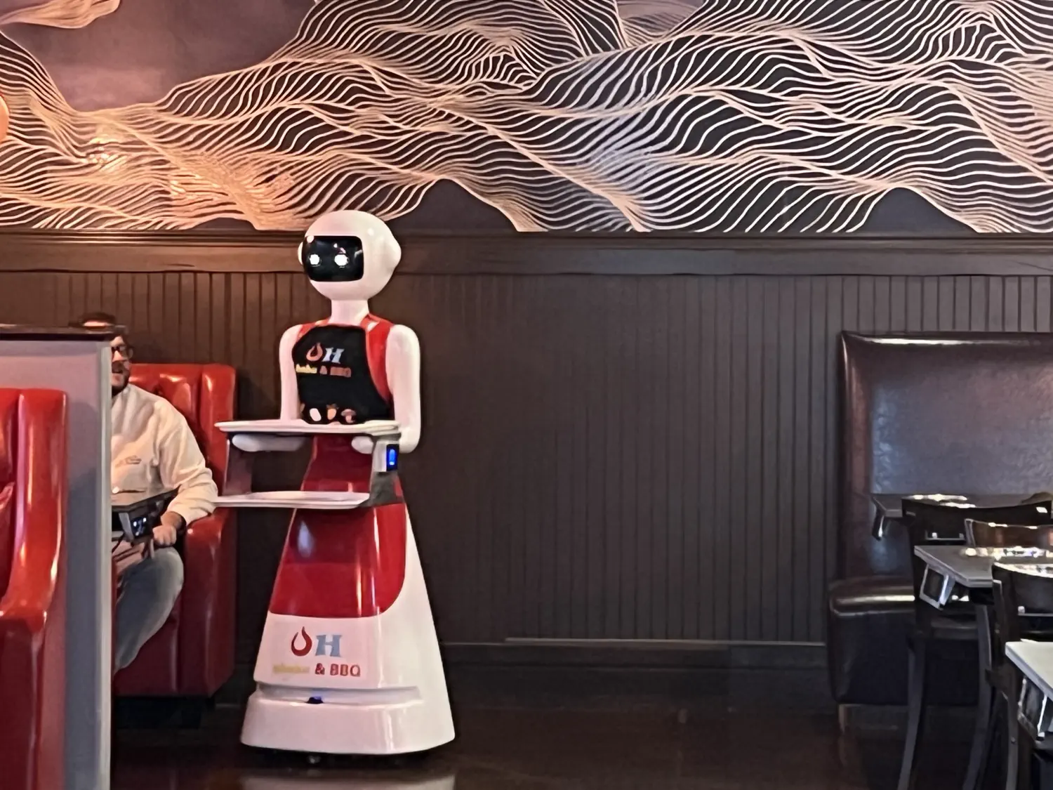 A robot waiter serves customers at Oh! Shabu Shabu & BBQ in South Jordan, UT