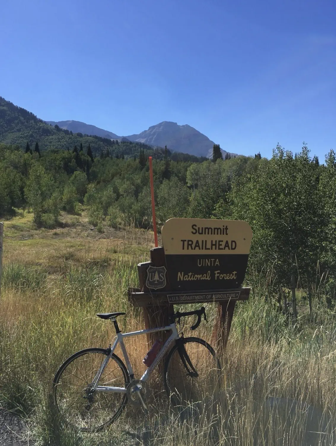 Yi's bike at the Uinta National Forest sign as he rode the Alpine Loop