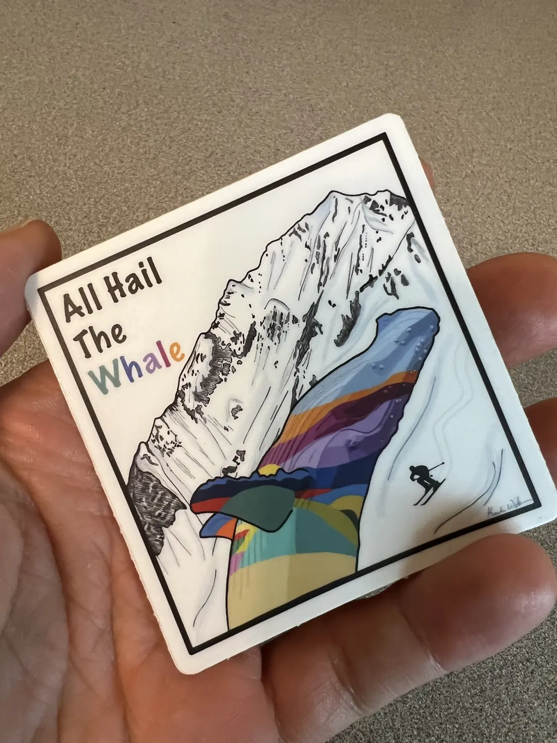 Keith is holding an "All Hail the Whale" sticker which celebrates the incredible snow in Utah