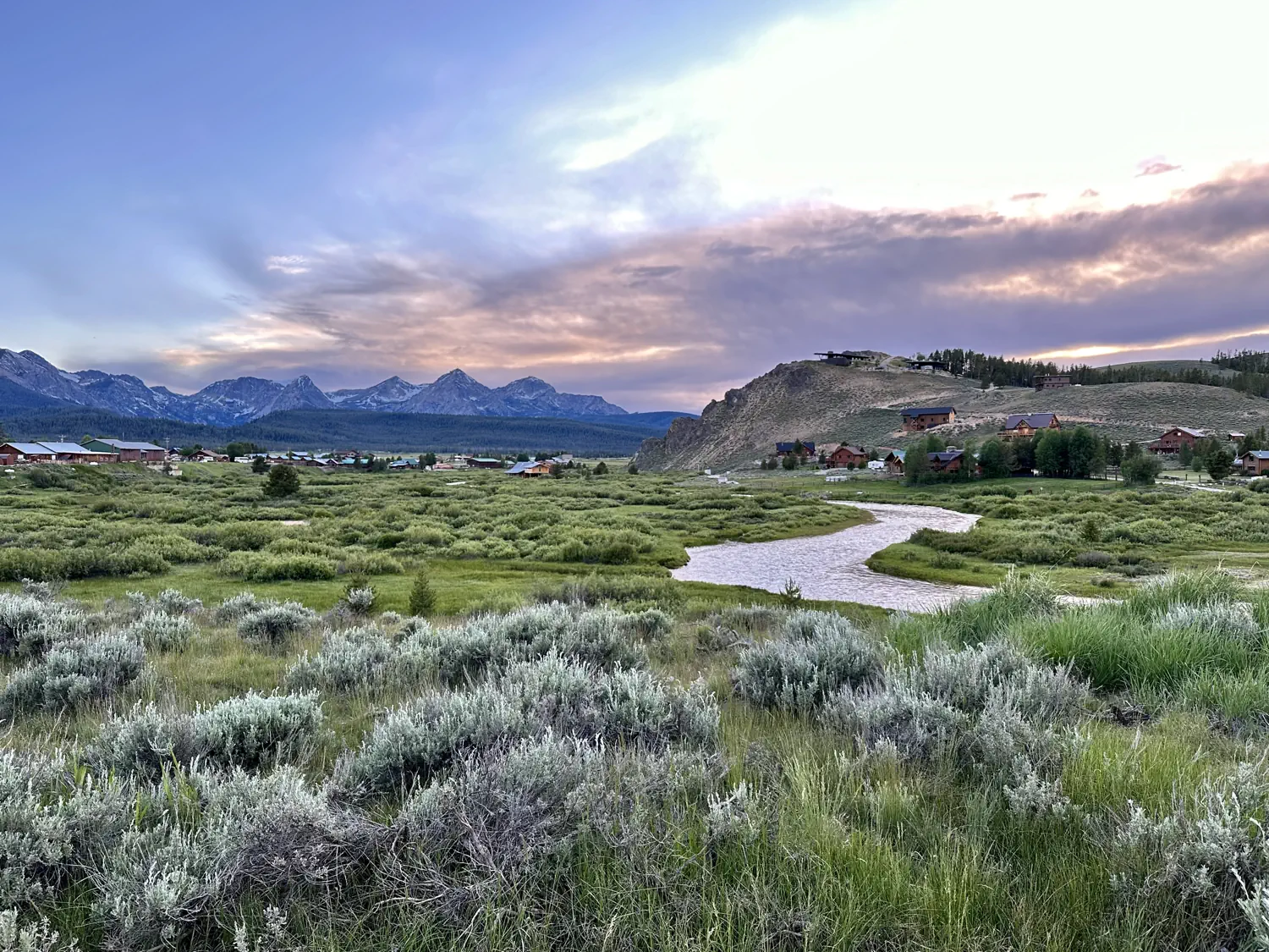 An incredible view of a winding river and the Sawtooth Mountain Range in the background