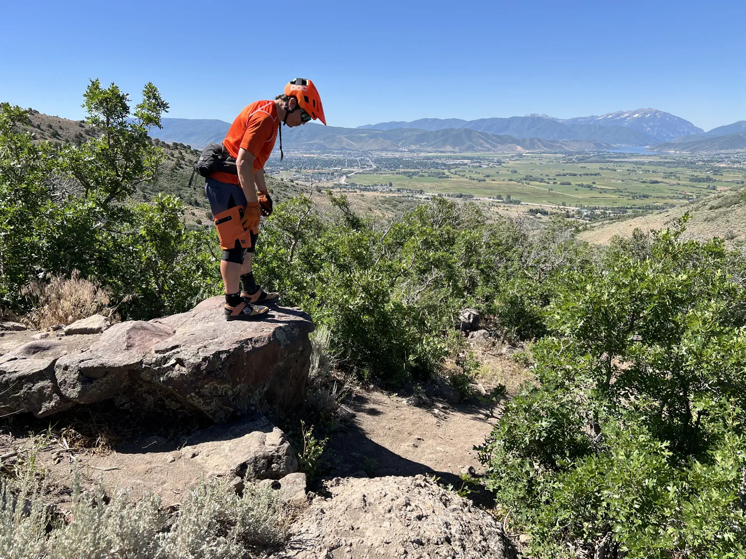 Brandon is scoping out the squirrel catcher, a 4-5 foot (1.2-1.5 meter) rock drop, at the start of the Mordor downhill trail