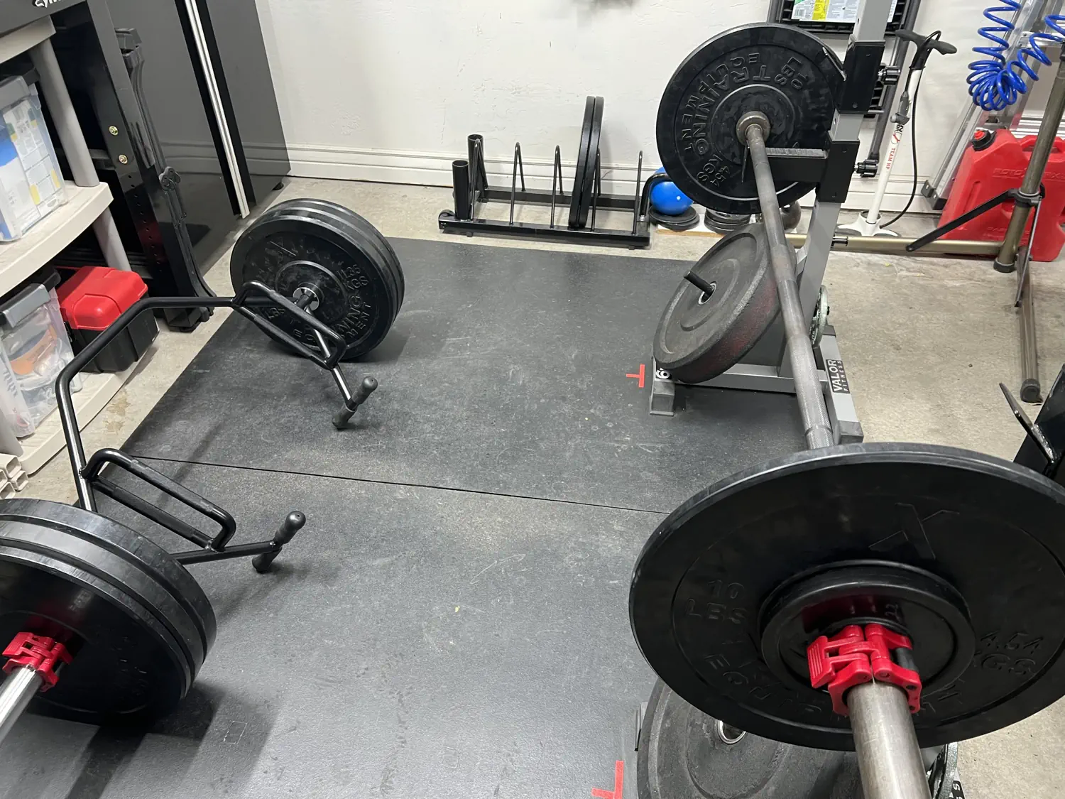 Keith's minimal home gym which includes a trap bar and barbell setup