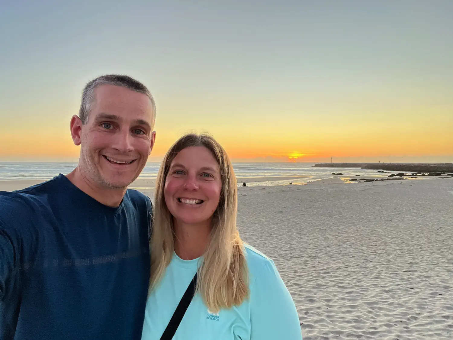Image of Keith and Lindsey relaxing along the beach in Portugal
