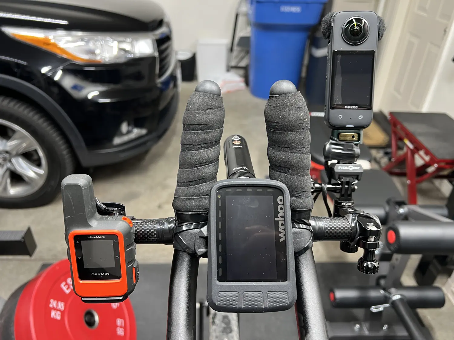 Keith's aero bar "cockpit" featuring his Garmin InReach Mini, Wahoo Elemnt Roam, and Insta360 X3 360 camera