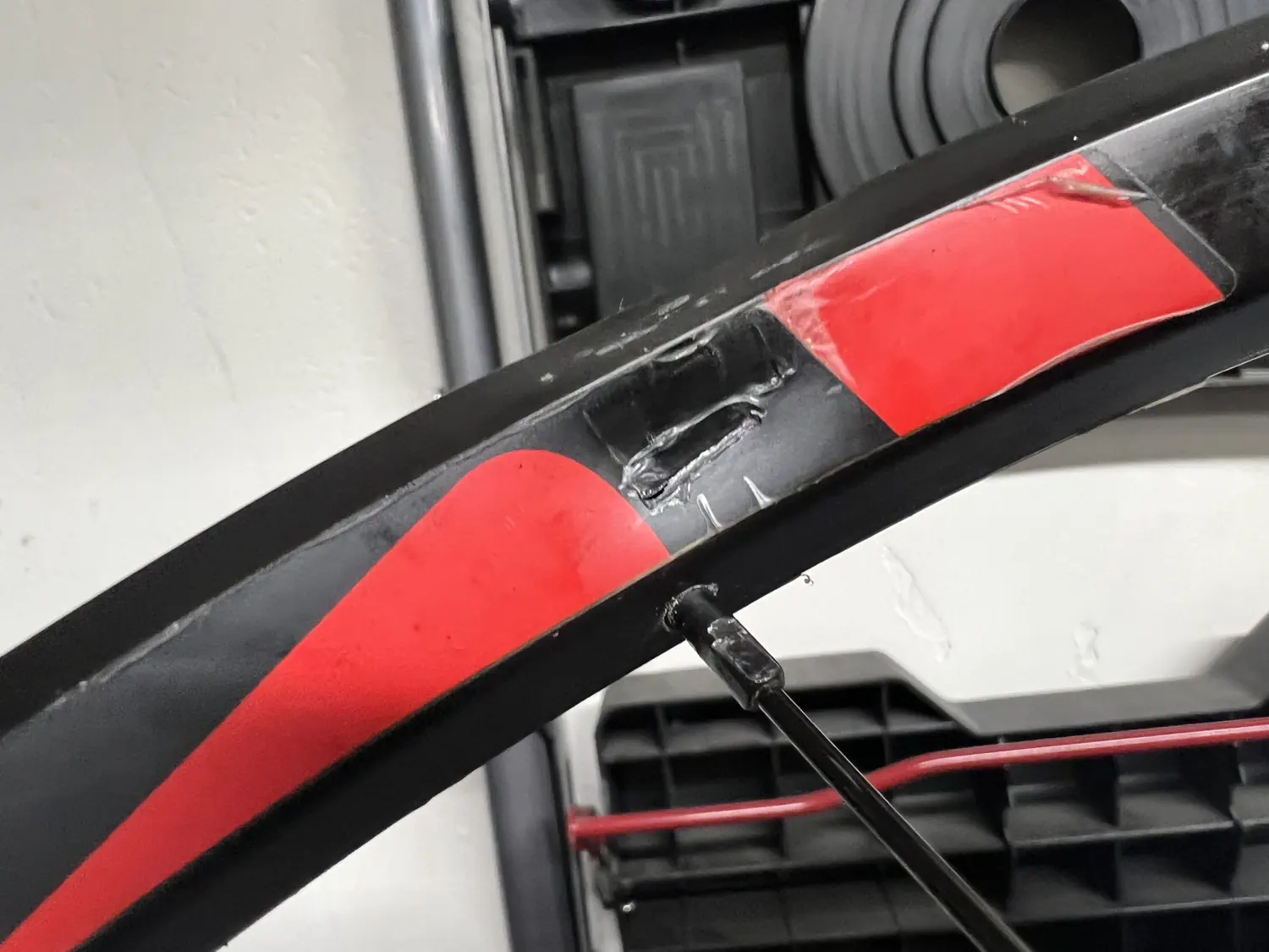 The damage caused by the local bike shop as they were attempting to repair a dent in the rim