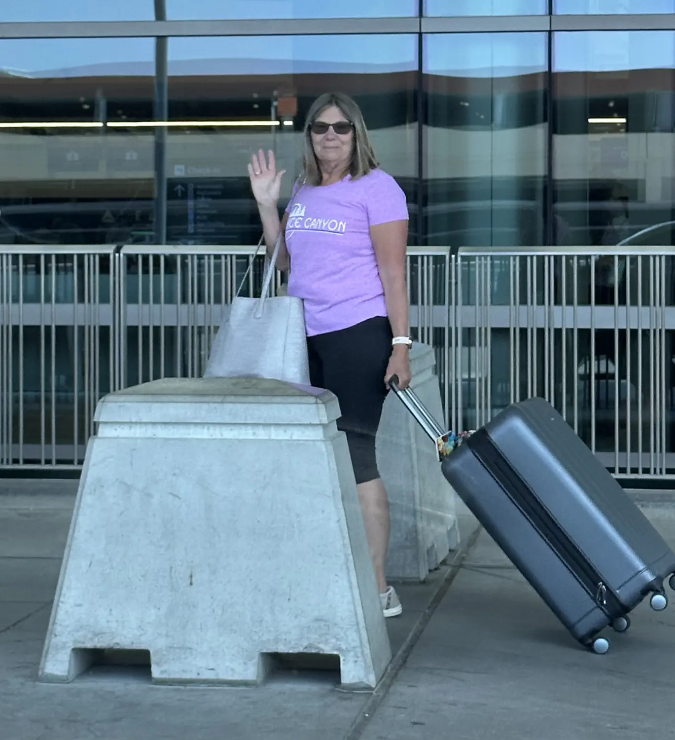 Lindsey's mom waving goodbye at the Salt Lake City airport as she flies back to Indiana