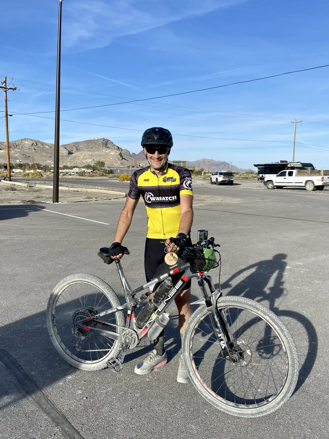 Keith is standing with his mountain bike after completing the 2022 Salty Lizard 100 gravel race
