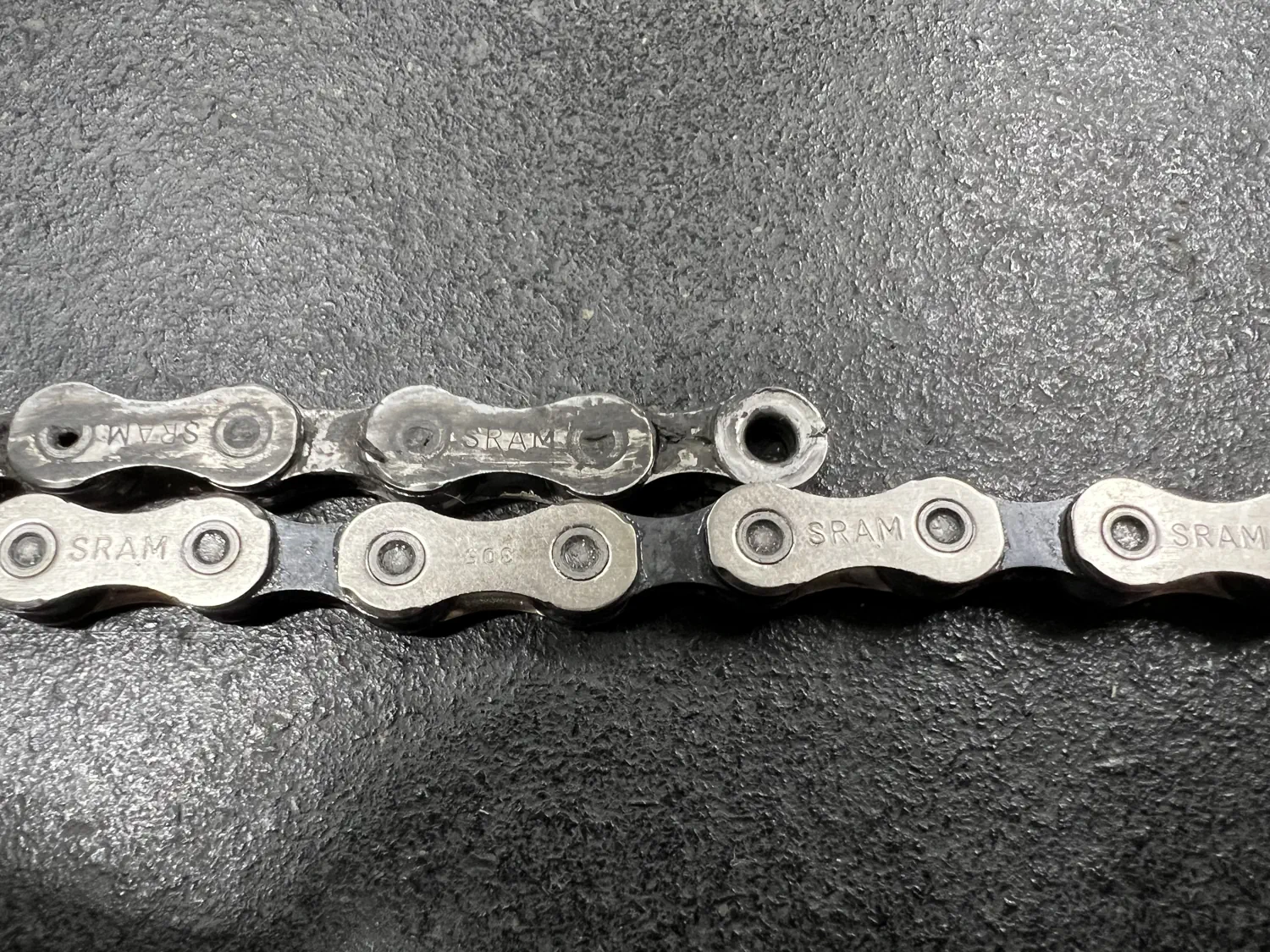 The old SRAM Eagle X01 chain (top) is showing minimal signs of chain "stretch"