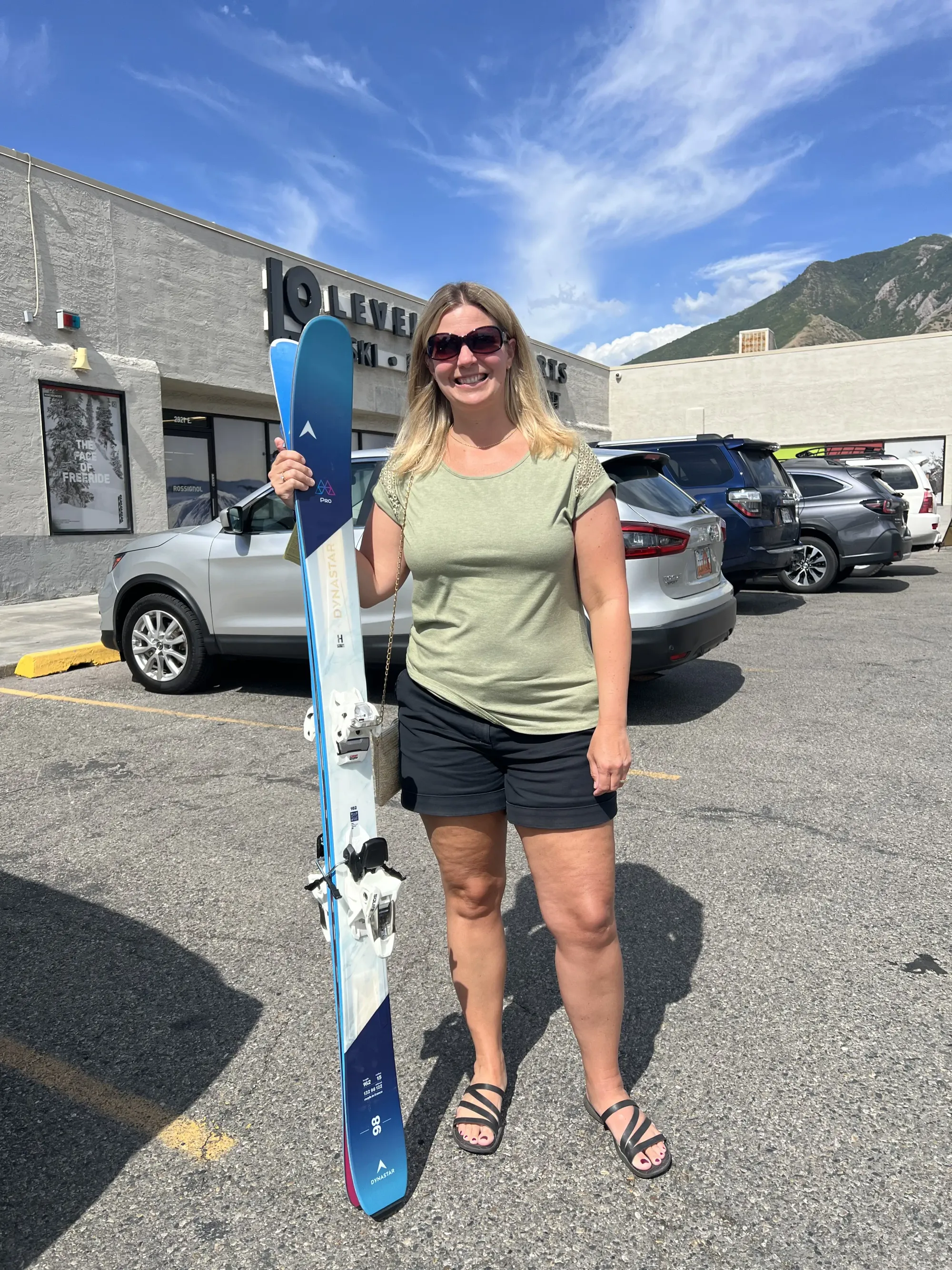 Lindsey is posing with her new Dynastar M-Pro 98 Skis - Women's 2026 edition skis paired with a new set of Marker Squire 10 Ski Bindings