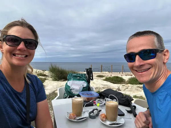 Keith and Lindsey enjoying a cafe stop with a beach view along the Camino de Santiago.